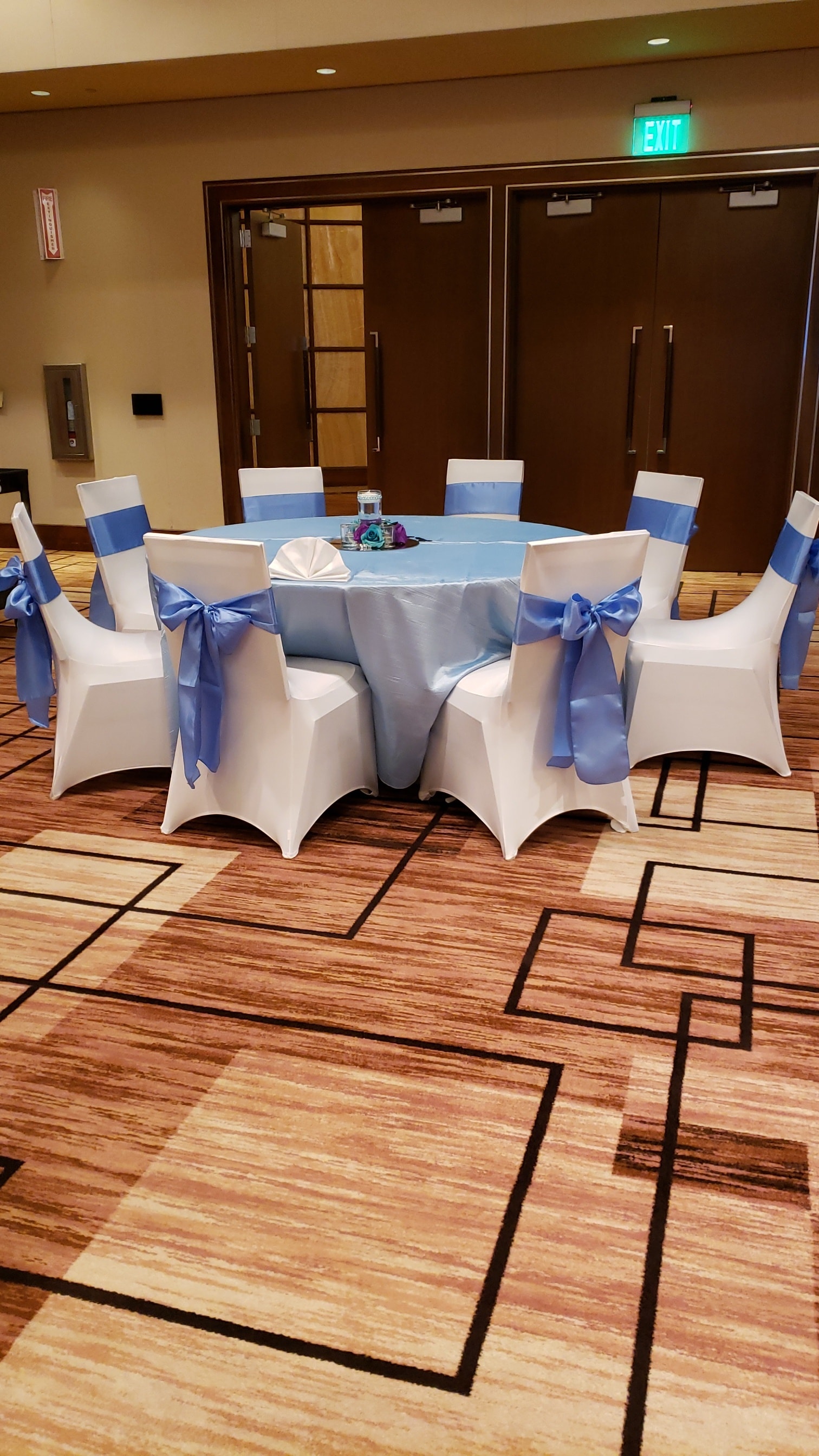 Blue tablecloth and sash round table setting