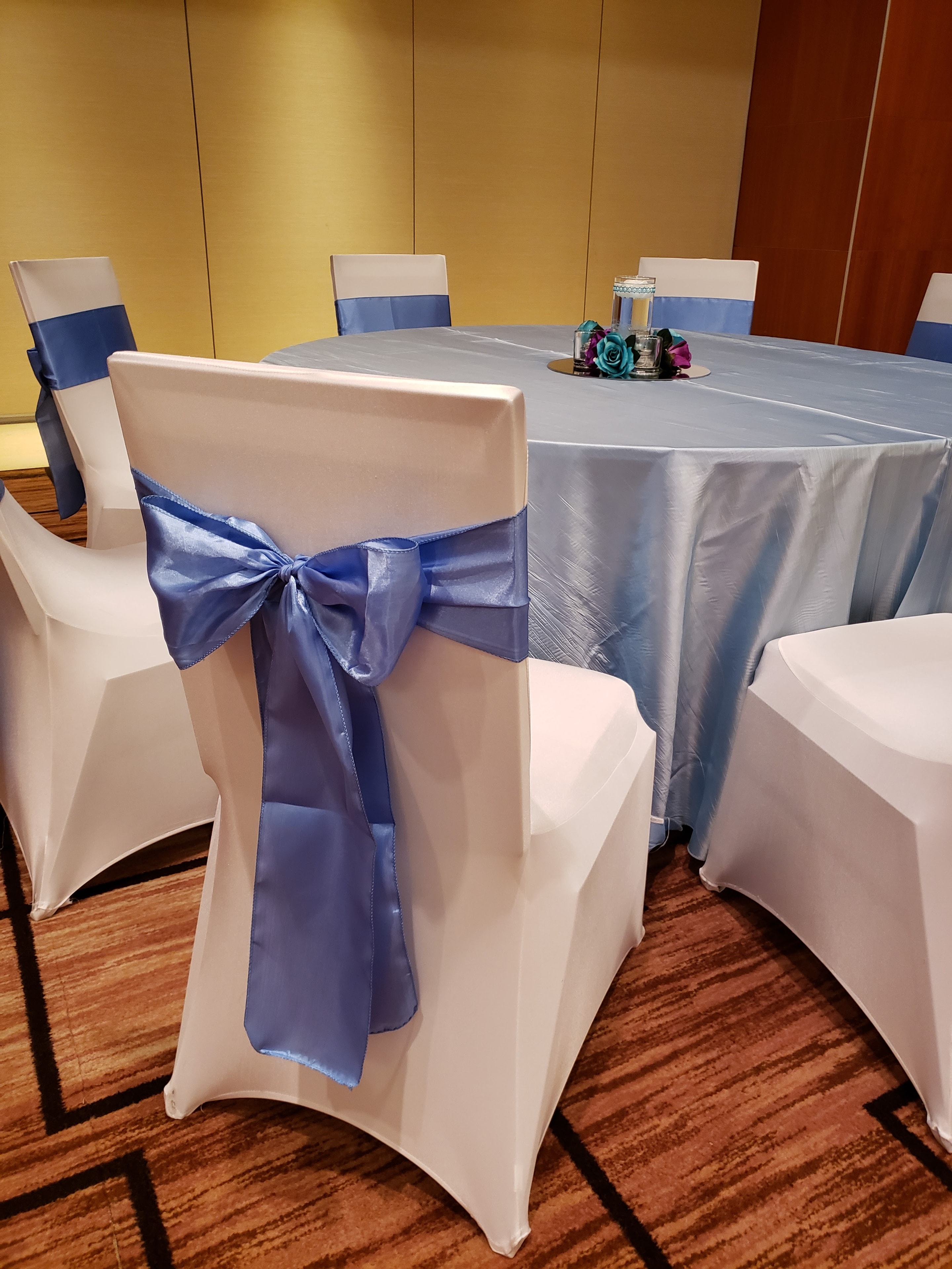 Periwinkle tablecloth with matching satin chair sash
