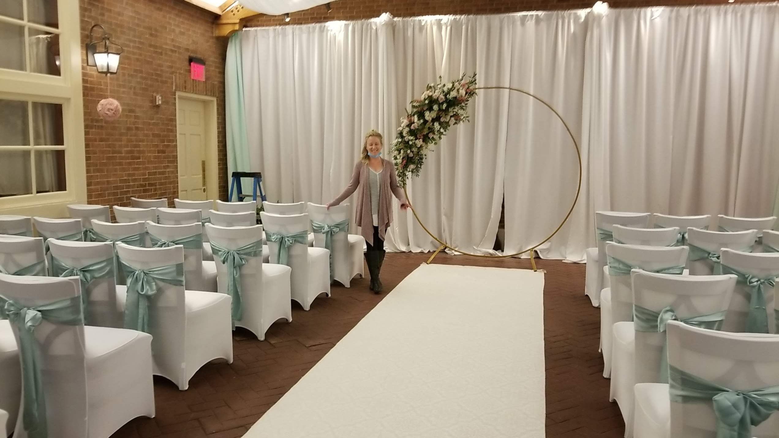 Mint sashes with white draping and floral hoop arch