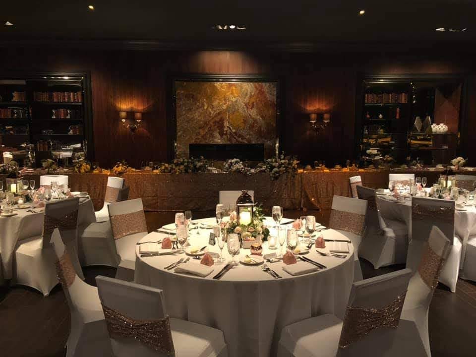 Dramatic black spandex covers with red satin sashes and ceiling draping