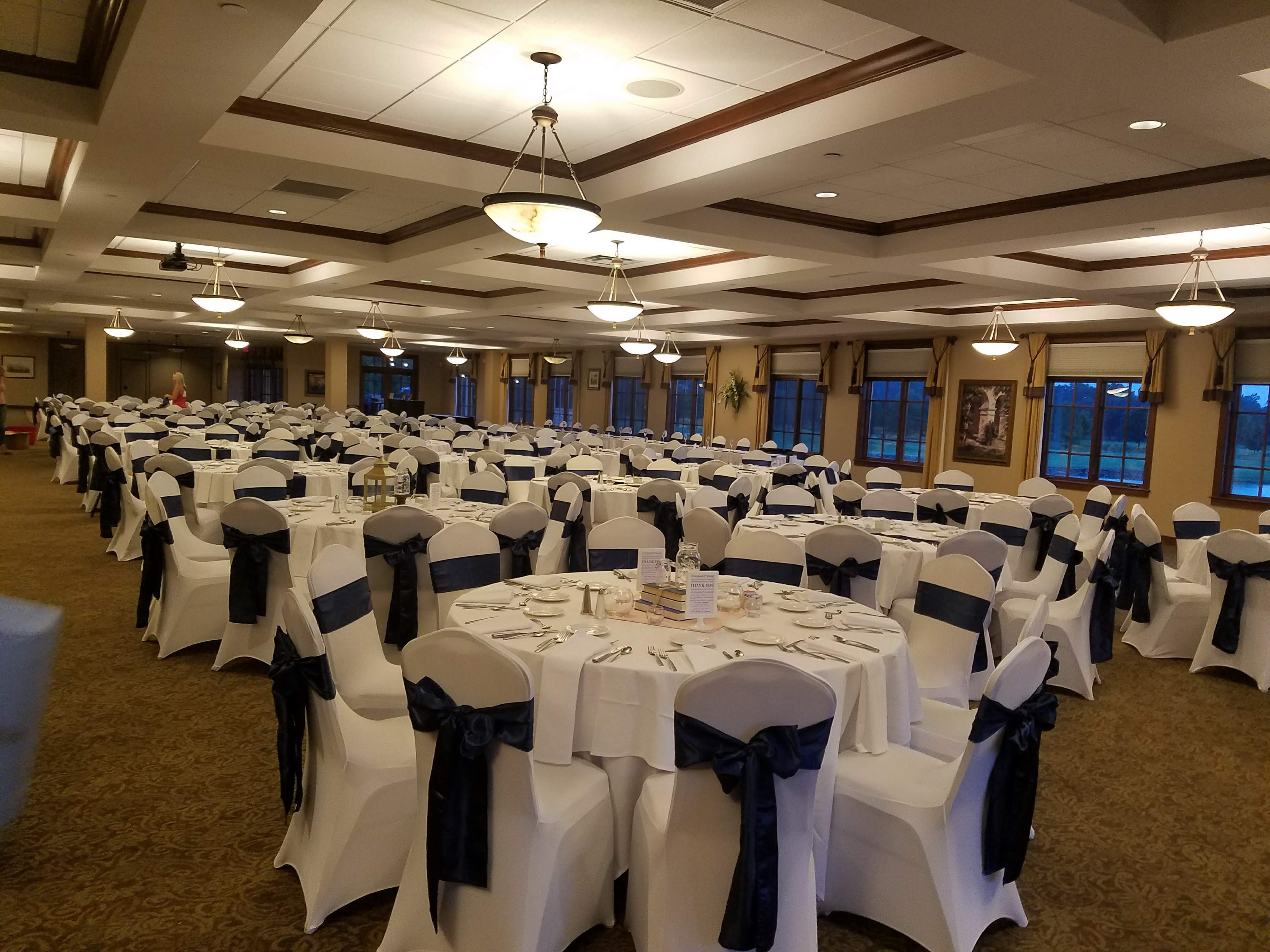 Classic white chair covers with navy sashes — timeless elegance